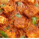 Paneer Tikka Masala with cream served in a bowl with rich tomato-based gravy and fresh coriander garnish.