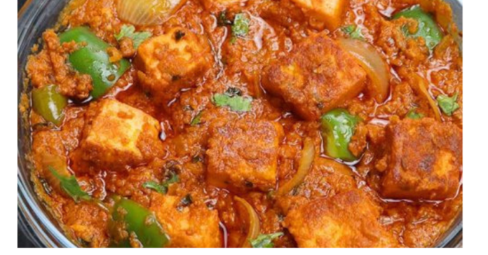 Paneer Tikka Masala with cream served in a bowl with rich tomato-based gravy and fresh coriander garnish.